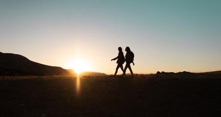 Fototapeta na wymiar two people walk along a mountain range