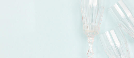 Banner with crystal glasses on a blue background. Composition with place for text.