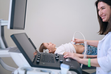 Cute child lies on a medical couch in ultrasound room