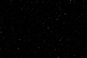 Obraz premium Black starry background with a dazzling starfield with stars and galaxies from outer space, the night sky, and the cosmos. AI generated.