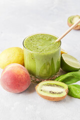 Healthy smoothie drink with kiwi, peach, orange and spinach. Vegan, healthy eating, KETO, plant-based diet