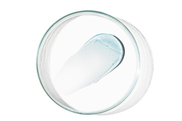 Petri dish with a drop and a smear of a transparent gel or serum on an empty background.