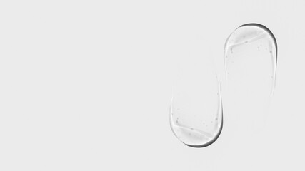 Composition of smears and drops or drops of transparent gel, serum. On a light background.