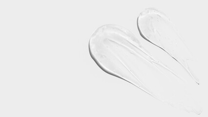 Composition of smears and drops or drops of transparent gel, serum. On a light background.