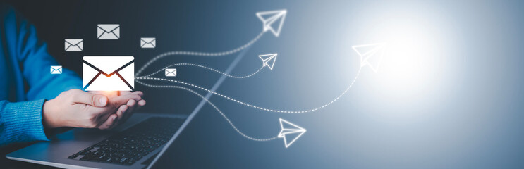 Business people working laptops with communication icons, letter icons, email icons, and newsletter...