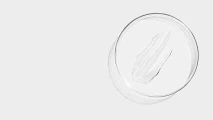 Petri dish on a light background, transparent gel smears. Empty place