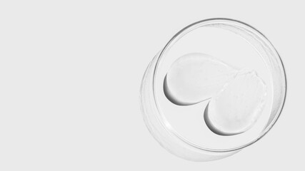 Petri dish on a light background, transparent gel smears. Empty place