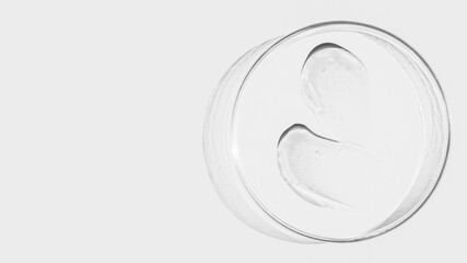 Petri dish on a light background, transparent gel smears. Empty place
