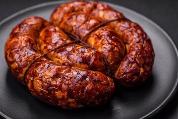 Delicious grilled sausage in the form of a ring with salt, spices and herbs