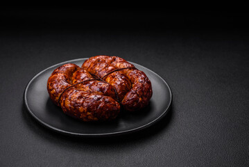 Delicious grilled sausage in the form of a ring with salt, spices and herbs