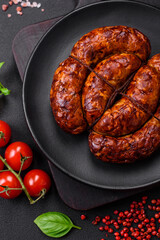 Delicious grilled sausage in the form of a ring with salt, spices and herbs