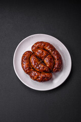 Delicious grilled sausage in the form of a ring with salt, spices and herbs