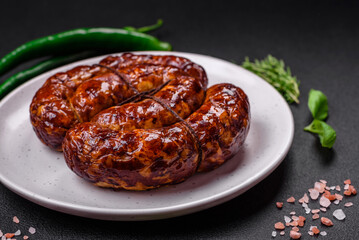 Delicious grilled sausage in the form of a ring with salt, spices and herbs