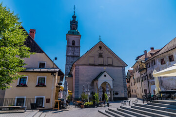 Fototapeta premium A view across the main square towards the cathedral in the town of Skofja Loka, Slovenia in summertime