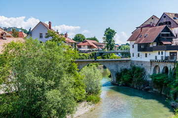 Fototapeta premium A view along the Selca Sora River in the town of Skofja Loka, Slovenia in summertime