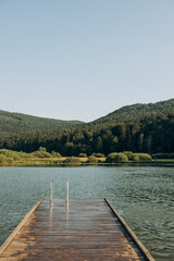 wooden pier lake surrounded by mountains, Slovenia. The concept of summer holidays, holidays