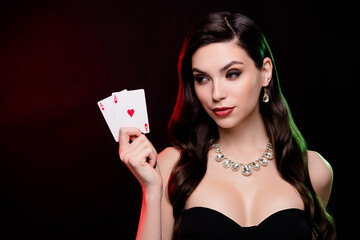 Stunning female dealer hold poker game two ace cards betting gambling poker club poker night...