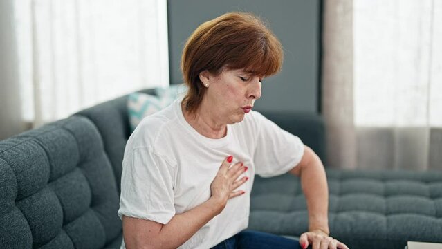 Middle age woman suffering heart pain home