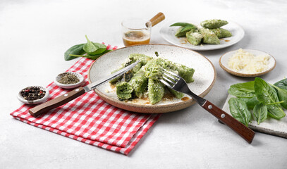 Ricotta and spinach gnocchi nd one is bitten . served with butter with sage and parmesan, italian cuisine Casentino region. Healthy dish with spinach