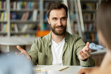 Portrait of smiling handsome bearded man, candidate talking, explaining something on job interview,...