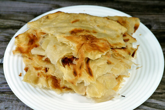 Egyptian Feteer meshaltet, layers upon layers of pastry dough with loads of ghee or butter in between, one of the famous Egyptian pastry recipes, a flaky Egyptian layered pastry bread dough and butter