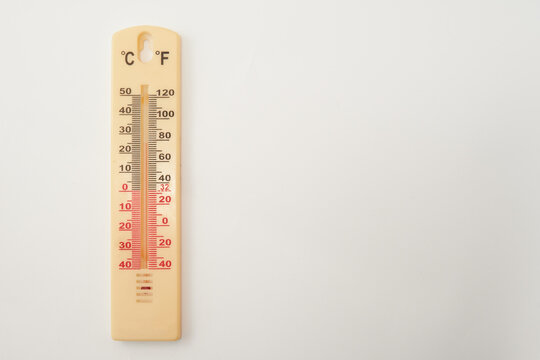 Thermometer for measuring air temperature isolated on white background. The thermometer shows plus 25 degrees Celsius 
