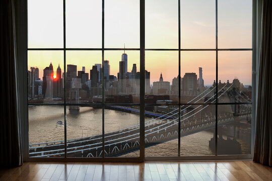 window view of sunset Manhattanhenge and Manhattan skyline NYC
