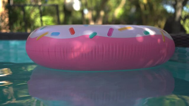 Inflable donut pool float circling in a private pool