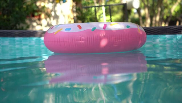 Inflable donut pool float circling in a private pool