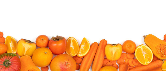 Panoramic set of ripe, juicy orange color fruits and vegetables on white background with copy space. Carrot, orange, persimmon, pumpkin, mandarin,