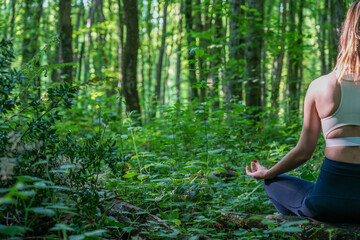 woman doing yoga in the forest closeup