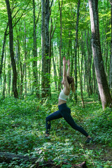 woman doing yoga in the forest