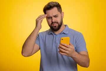 Caucasian man use mobile cell phone typing browsing, loses becoming surprised sudden lottery...