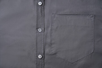 Gray shirt with pocket as background, top view