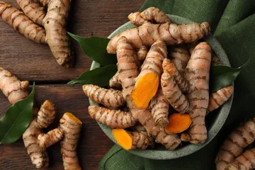 Fotobehang Fresh turmeric roots on wooden table, flat lay © New Africa