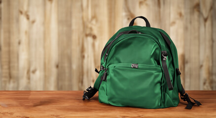 beautiful green bag on a wooden table with good lighting in high definition