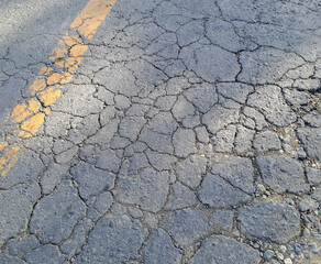cracks in asphalt roads as background. cracks in asphalt roads due to frequent heavy vehicles and poor road construction