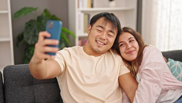 Man and woman couple make selfie by smartphone at home