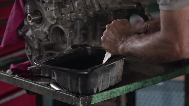 Car Engine Crankcase Cover Being Repaired With Sealing Liquid Gasket In The Repair Shop Footage.