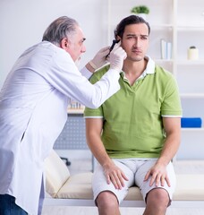 Male patient visiting doctor otolaryngologist