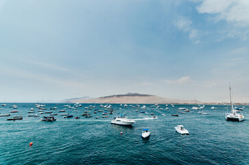Obraz premium Boats at sea with a mountain in the background. Summer Vacation Concept