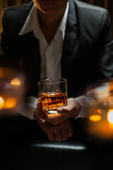 businessmen holding a glass of whiskey