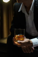 businessmen holding a glass of whiskey