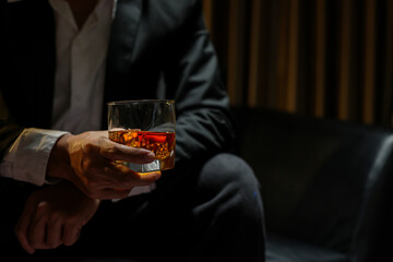 businessmen holding a glass of whiskey