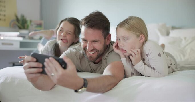 Funny, face and selfie with dad and children, girls or family with silly, goofy or joke photo for social media or profile picture. Father, kids or relax in bed together on phone in morning or home