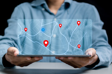 Businessman searching for location on map and pin on virtual screen. GPS app, Destination travel maps and find places in the online system © Pakin