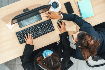 Business people wearing headset shot from top view in office working with computer. Jivy