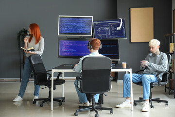 Team of young programmers working in office