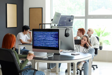 Team of young programmers working in office