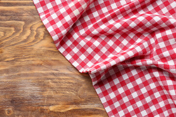 Fototapeta na wymiar Red checkered napkin on wooden background